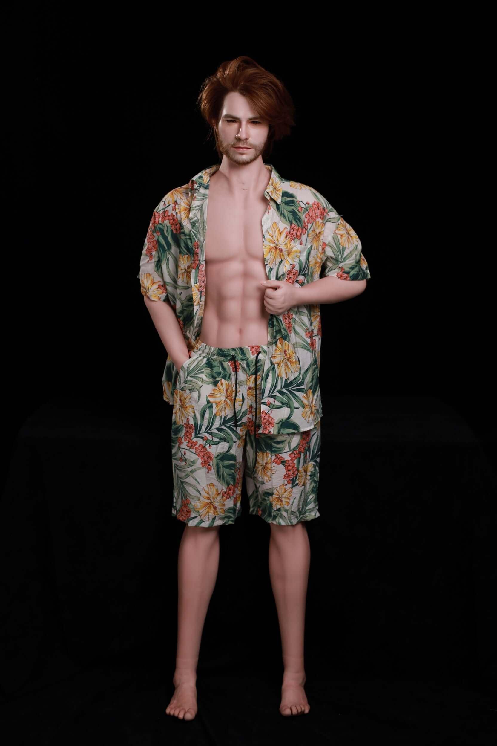 Mason 160cm silicone male doll standing barefoot in tropical floral two-piece set, swept-back auburn hair, masculine sculpted torso - full-length dark studio shot