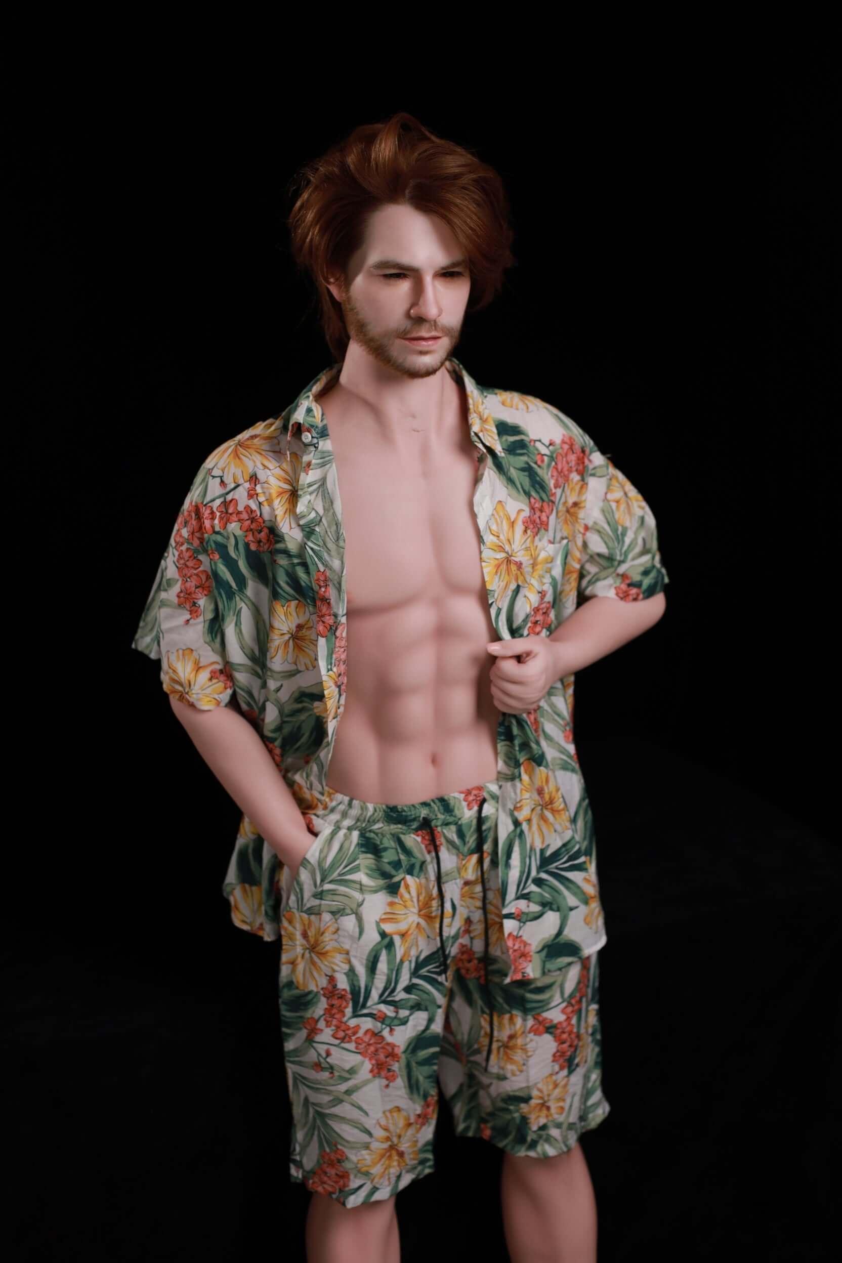 160cm Mason 1:1 male doll full-body standing pose in cream tropical floral shirt and shorts, defined six-pack visible, auburn medium-length hair - black backdrop