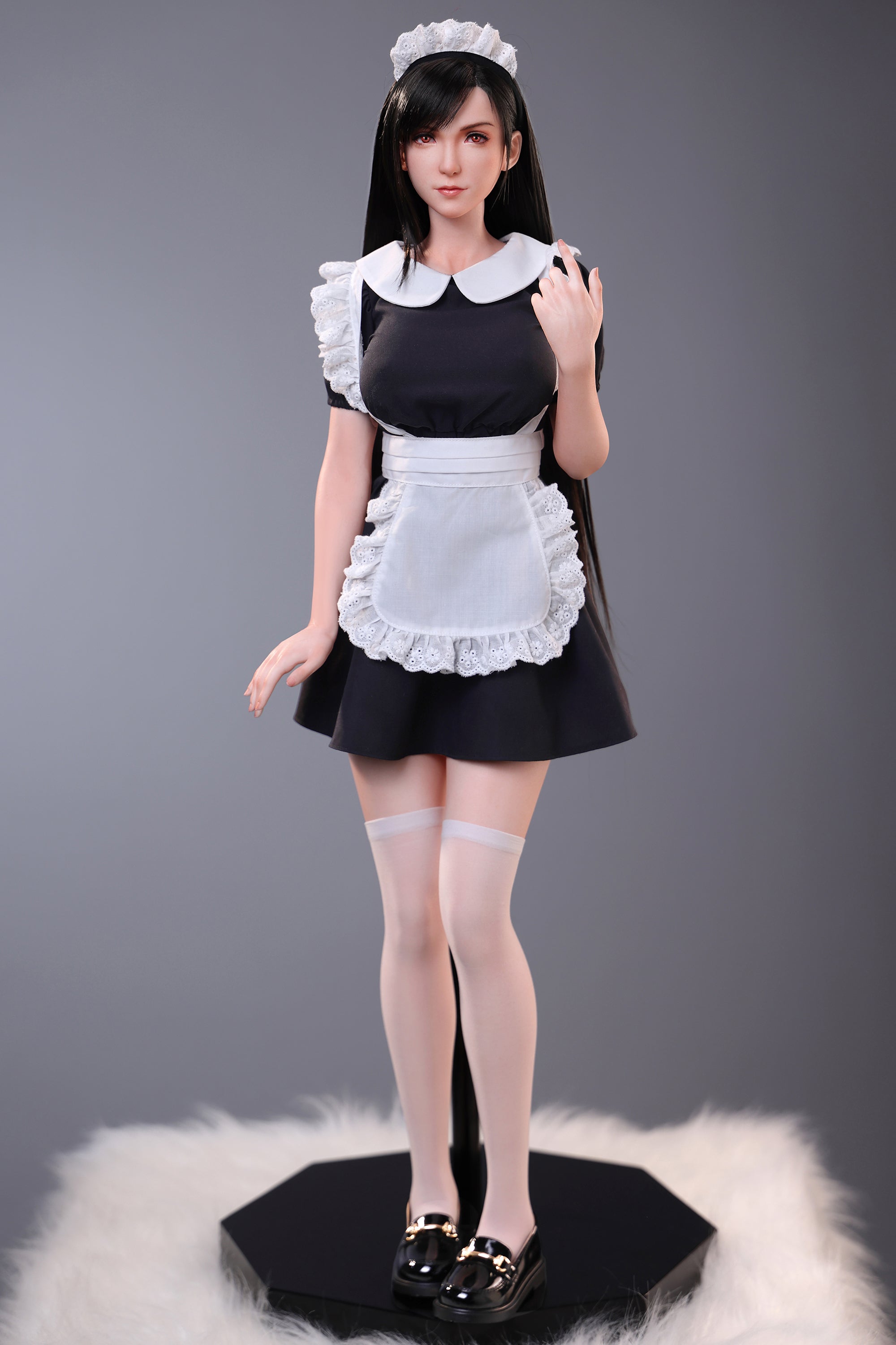 Doll in a maid outfit on a gray background