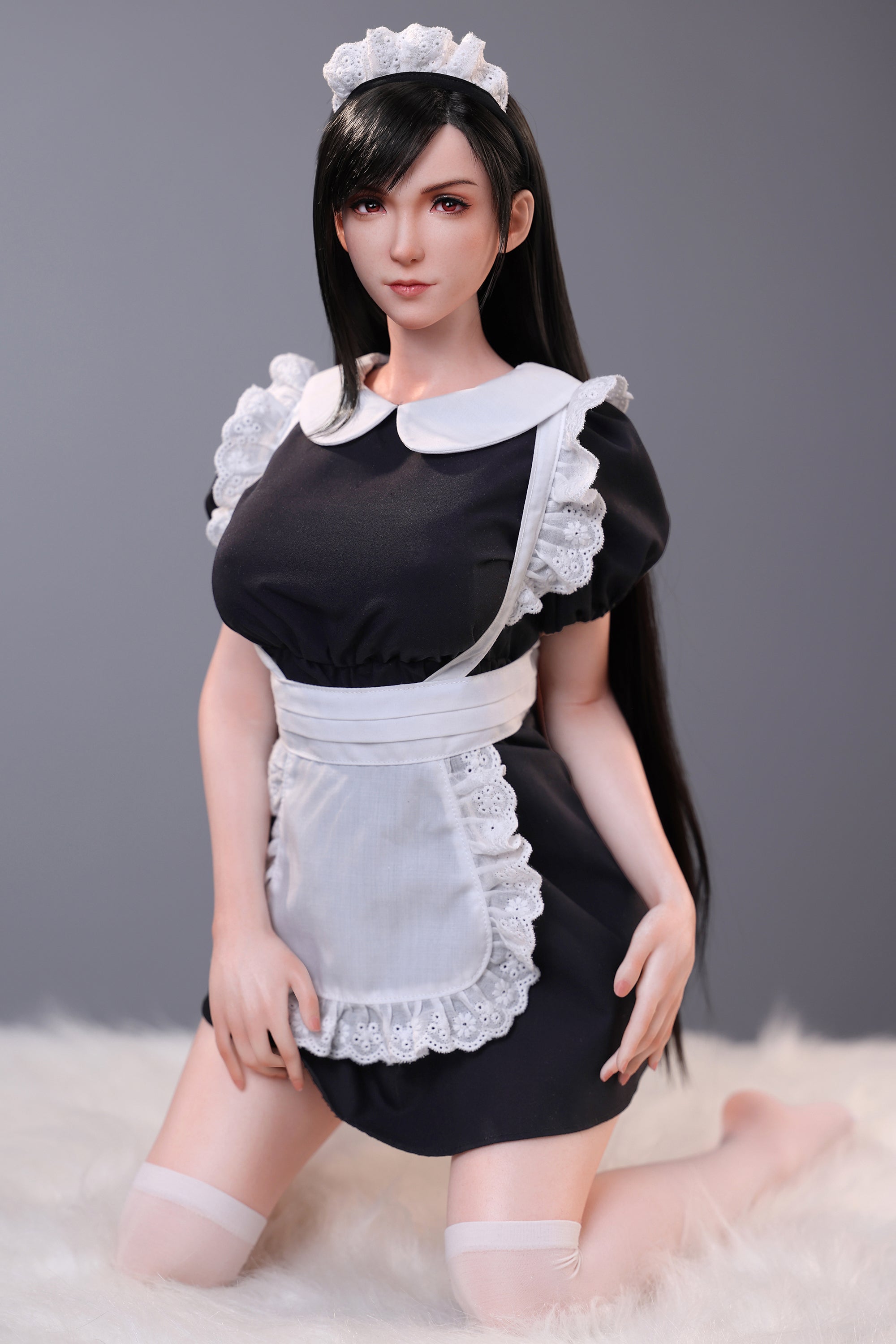 Person wearing a black maid outfit with white apron and headband on a gray background