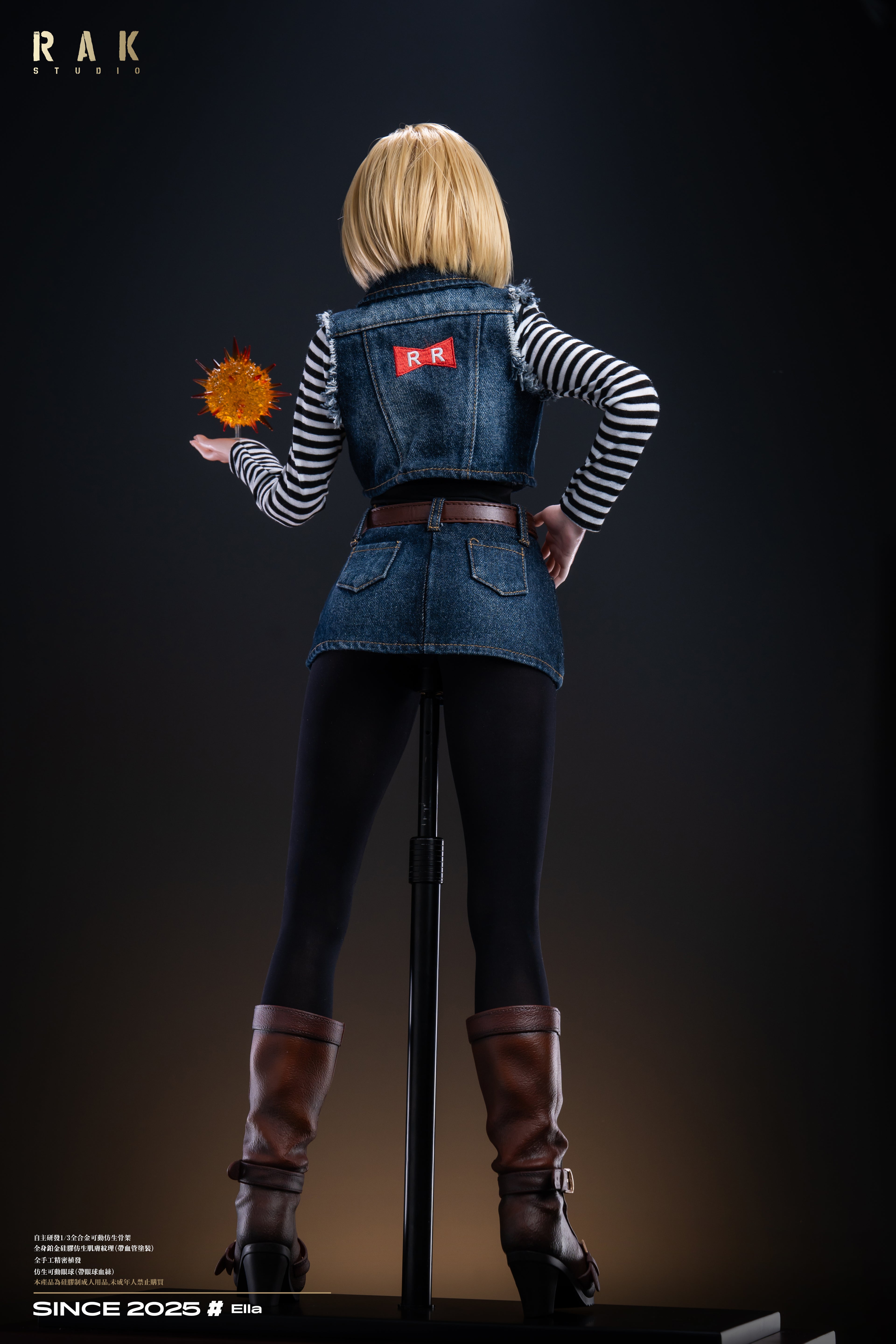 Action figure with a denim outfit and blonde hair, holding a flower, on a dark background.