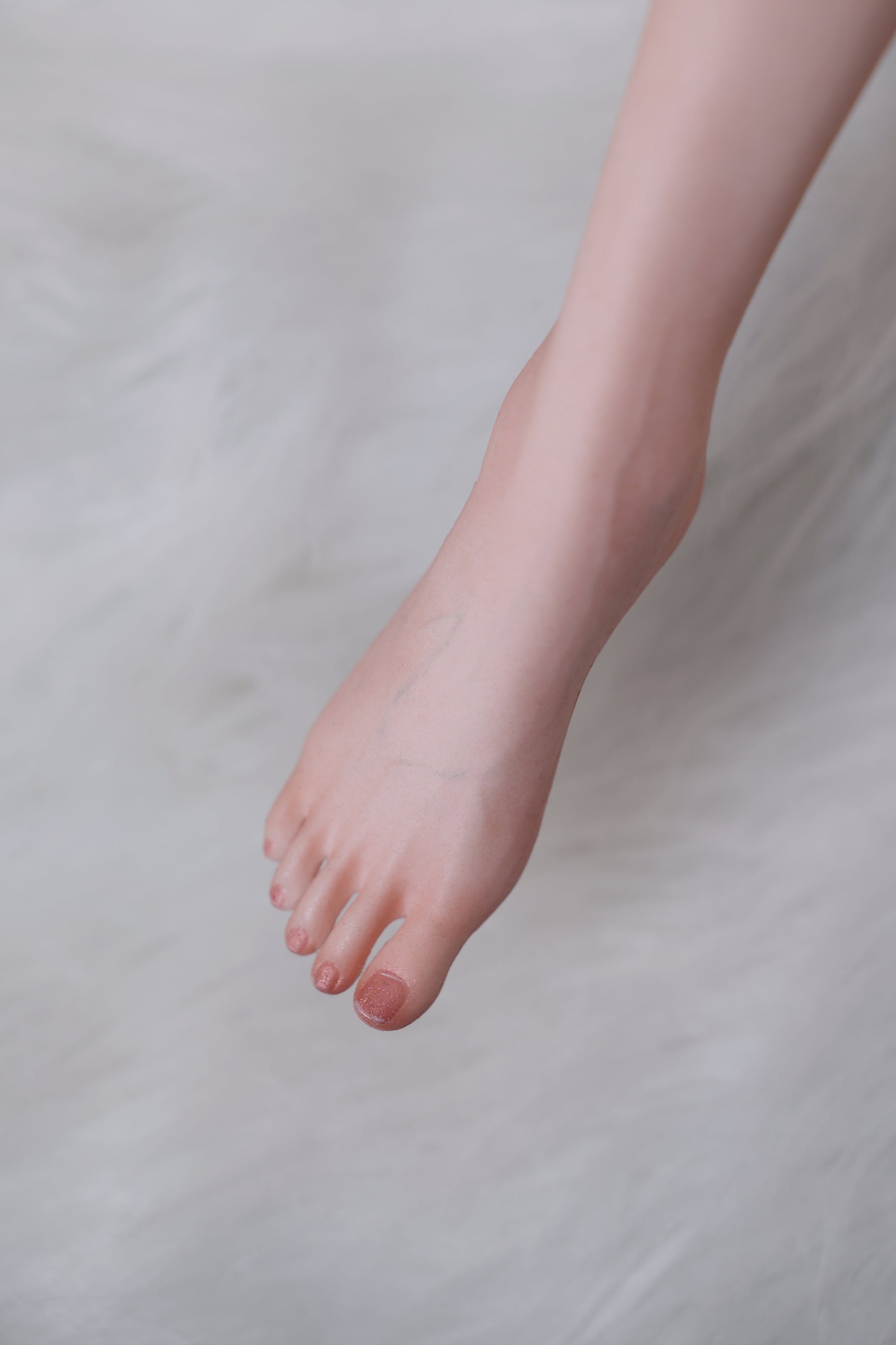 Close-up of a bare foot on a neutral background